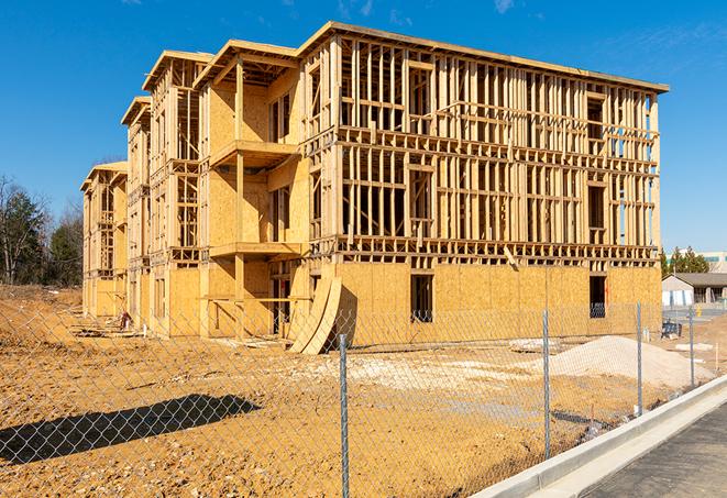 a temporary chain link fence winding around a construction site, outlining the project's progress in Durant, IA